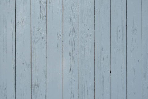 Light blue wooden wall with vertical planks and visible joints, simple and plain texture,