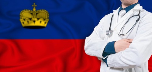 Liechtenstein healthcare concept. Male doctor on Liechtenstein flag. Doctor with crossed arms on