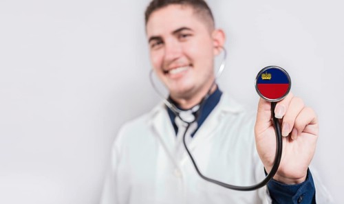 Doctor showing stethoscope with Liechtenstein flag. Liechtenstein national healthcare concept