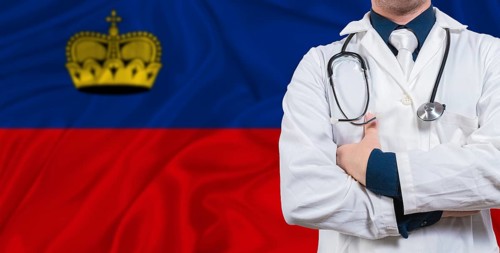 Male doctor with stethoscope on Liechtenstein flag. Doctor holding stethoscope on Liechtenstein