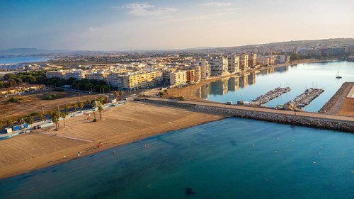 Aerial view of torrevieja coastline reflecting in mediterranean sea at sunrise, featuring acequion