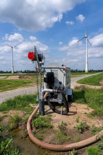 Mobile pump for artificial irrigation with a sprinkler system in a field where sugar beet is grown,