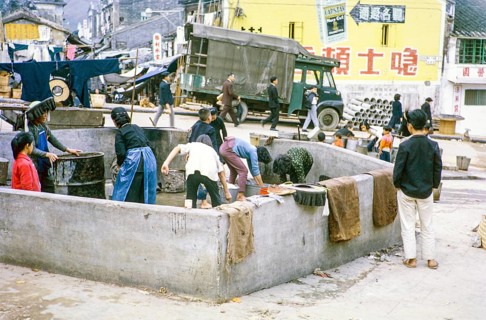 Women washing clothes in street at public laundry place, Tai Po, New Territories, Hong Kong, Asia,