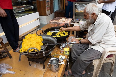 Indian man frying local sweet in the old town of Jaisalmer, Rajasthan, India
