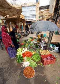 Indian woman at a market stall in the old town of Jaisalmer, Rajasthan, India