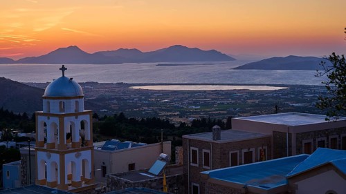 A church at sunset with a view of the sea and the islands, salt lake, Tigaki, nature reserve, hydro