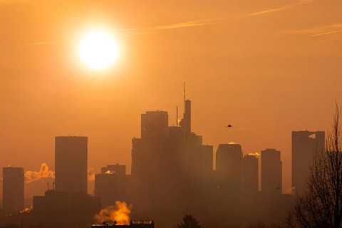 The sun rises behind Frankfurt's banking skyline, Frankfurt am Main, Hesse, Germany