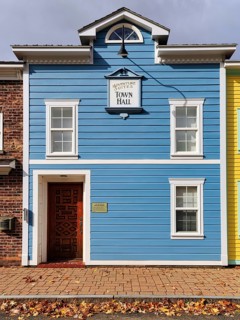 Replica, historic city hall, blue facade, sign with inscription, fall leaves, boutique hotel, theme