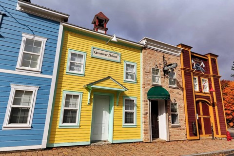 Replica, historic elementary school, colorful facades, signs with inscription, boutique hotel,