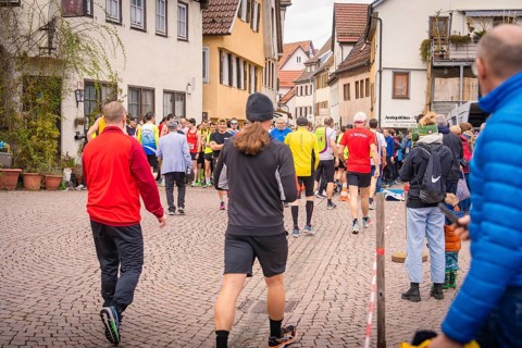Group of people in sportswear on paved village road, triathlon, Calw, Germany