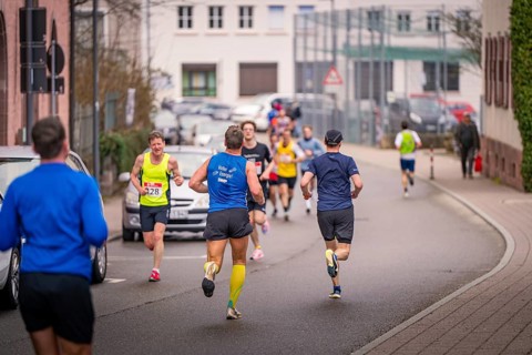Runners moving on a street, residential building in the background, triathlon, Calw, Germany