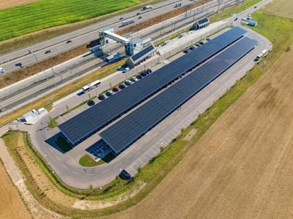 Aerial view of a parking lot with solar panels and vehicles on a street, e-charging park,