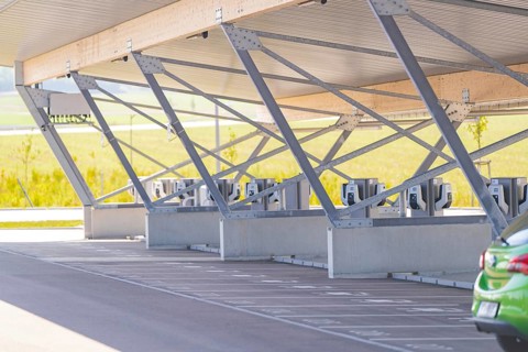 Modern architecture of a parking garage with charging stations and metal supports, e-charging park,