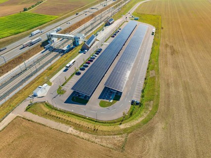 Parking lot with solar panels near fields, taken from the air, e-charging park, Merklingen, Germany