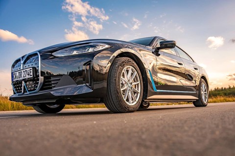 Black car on the road from a frog's eye view with blue sky, BMW i7 electric car, Deer e-Carsharing,