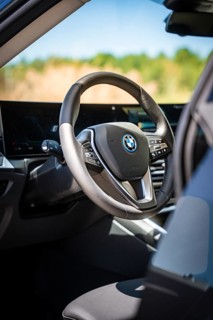 View of the modern steering wheel and display in the interior of a car, BMW i7 electric car, Deer