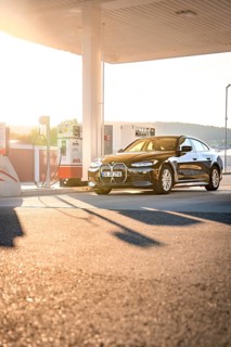 BMW at a gas station during sunset, BMW i7 electric car, Deer e-Carsharing, Calw, Germany