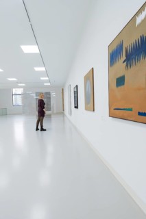 Visitor looks at paintings in a modern, light-filled gallery, Schauwerk, Sindelfingen, Germany