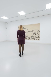 A woman stands in front of a modern work of art in a bright gallery, Schauwerk, Sindelfingen,