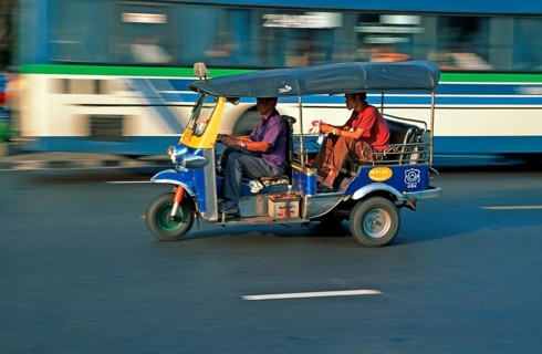 Passenger in a three-wheeled tuk tuk taxi, blurred, Bangkok, Thailand, December 2002, vintage,