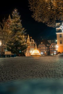 Atmospheric view of the old town at night, illuminated with lights, Christmas tree and
