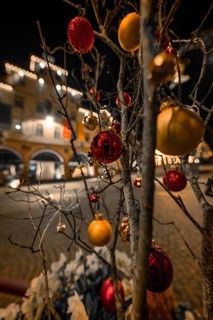 Christmassy decorated tree with balls and lights in a nighttime street scene, Calw, Black Forest,