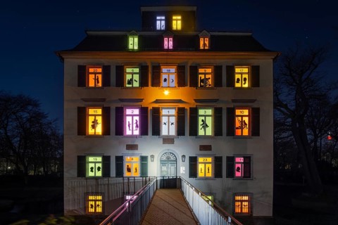 The windows of the Holzhausenschlösschen in Holzhausenpark in Frankfurt am Main shine brightly in