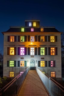 The windows of the Holzhausenschlösschen in Holzhausenpark in Frankfurt am Main shine brightly in