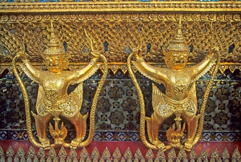 Golden mythical creatures, statues, Garudas, at Wat Phra Kaeo, Bangkok, Thailand, December 2002,