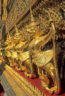 Golden mythical creatures, statues, Garudas, at Wat Phra Kaeo, Bangkok, Thailand, December 2002,