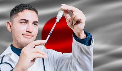 Doctor holding syringe on Japan flag background. Medical professional holding syringe with Japanese