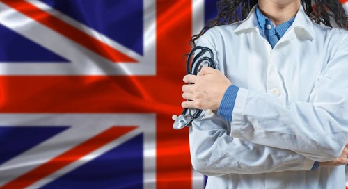 Healthcare professional with United Kingdom flag background. Professional doctor holding