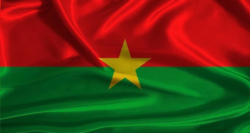 Burkina Faso flag with cloth textured background. National flag of Burkina Faso with realistic