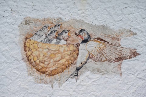 Swallow feeding her young in the nest, a painting on a farmhouse, Morschreuth, Upper Franconia,