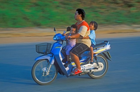 Father with his two children on a moped, Krabi, Thailand, December 2002, vintage, retro, old,