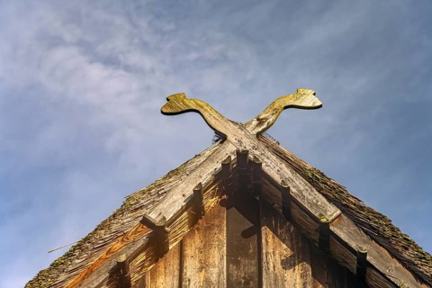 Typical traditional pediment with the symbol of two crossed snakes in the open-air museum near