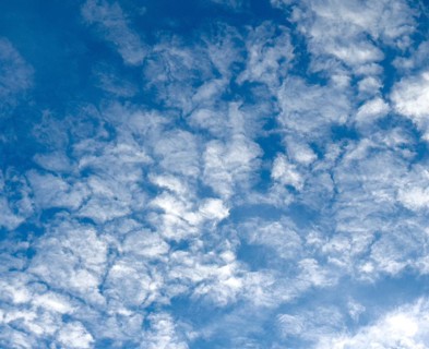 Medium-high white clouds of Altocumulus fractus in blue sky, international