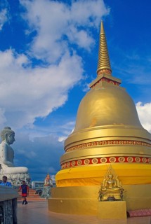 People, Buddha statue, chedi in Wat Tam Sua monastery, which is partly on the top of a mountain,