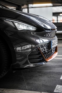 Close-up of a modern black car in underground garage with sporty design, Cupra electric car, e-car