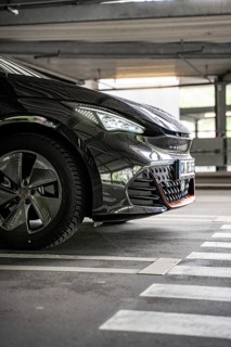 Close up of a black car in an urban parking lot from the front, electric car Cupra, e-car sharing,