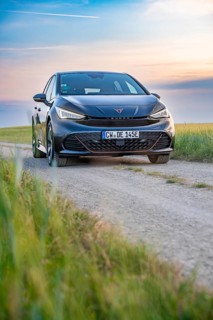 Car on a dirt road at dusk with fields in the foreground, electric car Cupra, e-car sharing, Calw,