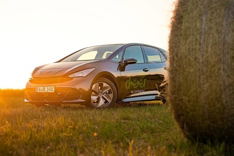 Car next to a hay bale in a rural landscape at sunset, electric car Cupra, e-car sharing, Calw,