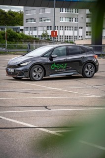Black car sharing car parked in vacant area, modern city vehicle, Cupra electric car, e-car