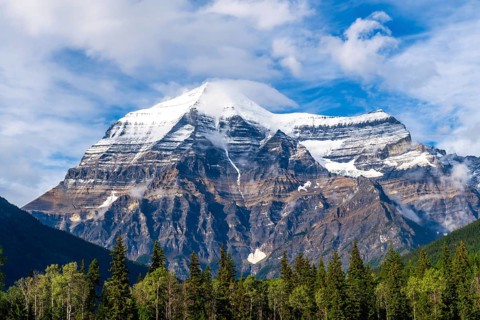 Mount robson, towering in the canadian rockies, showcases its snow capped summit and rugged slopes