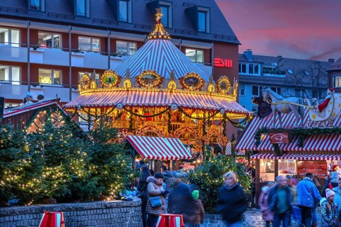 Nostalgic children's carousel at the children's Christmas market in the evening, Hans Sachs Platz,