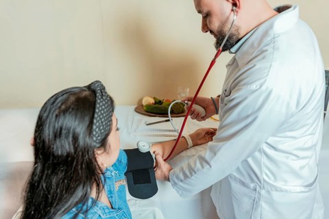 Nutritionist measuring blood pressure to patient. Measuring blood pressure to patient in the