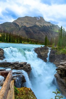 Athabasca falls cascading powerfully over rocky cliffs in jasper national park, alberta, canada,