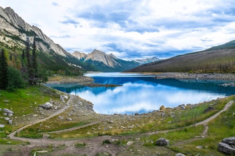 Winding hiking trails traverse the scenic landscape leading to medicine lake, nestled among the