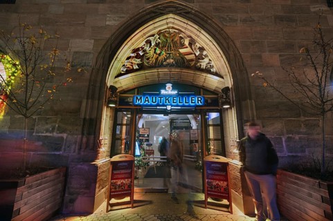 Historic entrance portal to the former Mauthalle, with imperial eagle and city coat of arms, built