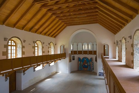Large church room in wooden design with gallery and many windows. Light floods the room, German